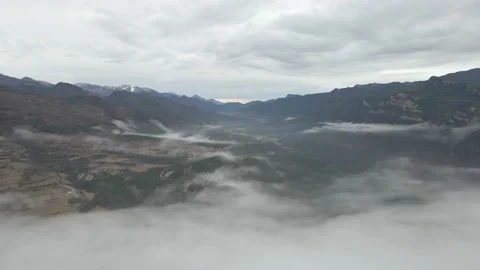 The drone flies above the clouds towards the beautiful mountains Видео 246627049
