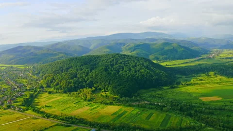 Drone flies above green fields in Carpathians Stock Footage 137068769