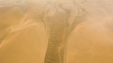 The drone flies above the sandy beach. Stock Footage 114528031