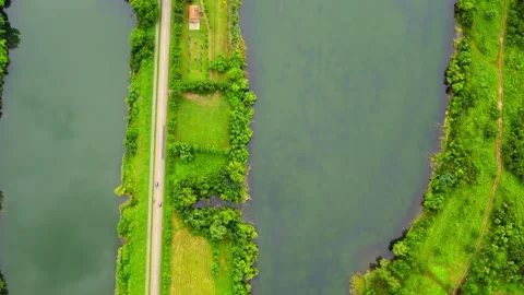 Drone flies above two lakes in Bela Crkva with road passing between them Stock Footage 269165345
