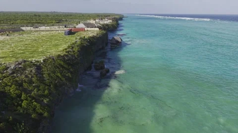 Drone flies along coast during high tide at Mtende Beach on a windy day Stock Footage 344119645