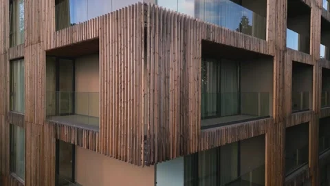 A drone flies along the facade of a modern hotel. Windows and balconies are Stock Footage 255833906