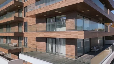 A drone flies along the facade of a modern hotel. Windows and balconies are Stock Footage 255836778