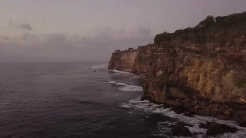 The drone flies along the mountain that is washed by the sea. Stock Footage 155998684