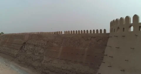A drone flies along the old wall of a fortress in Bukhara near the Talipach Gate Stock Footage 246783757
