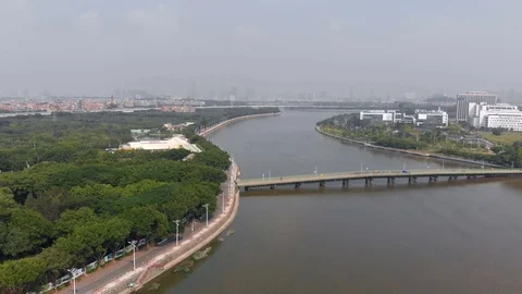 A drone flies along the river. In the frame, a bridge connecting two banks. Stock Footage 117921326