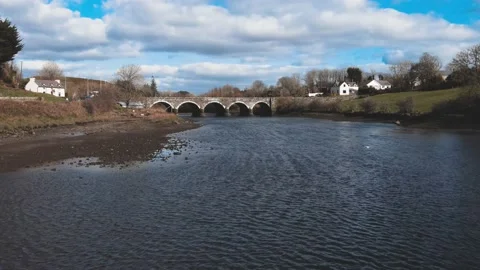 The drone flies along the river to the old footbridge in Ireland Video stock 234111406