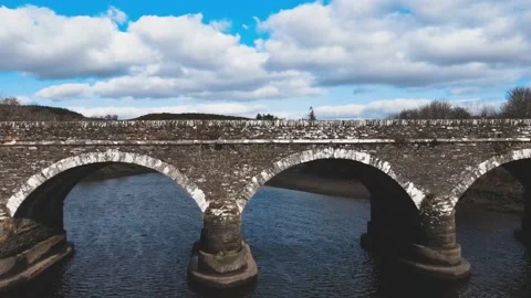The drone flies along the river to the old footbridge in Ireland Video stock 234111422