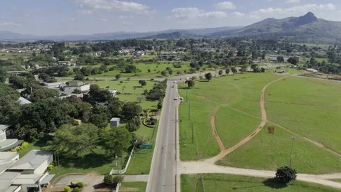 Drone flies along road between Parliament and Somhlolo National Stadium Vídeo Stock 333279684