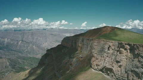 Drone flies along the steep slope of mountain Stock Footage 165568941