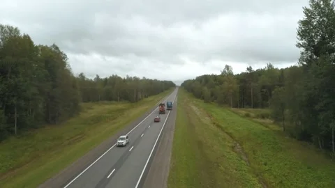 The drone flies along the track behind the cars, the truck has created a traffic Stock Footage 169580684