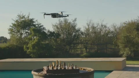 A drone flies and then falls on a chessboard causing all the pieces to fly Stock Footage 206010556