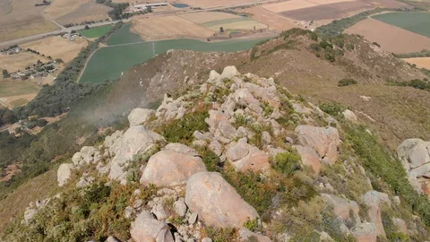 Drone flies around in complete circle while young man stands on mountain peak Stock Footage 128274988