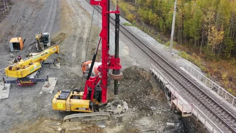 Drone flies around construction drilling machine 4k Stock Footage 236400001
