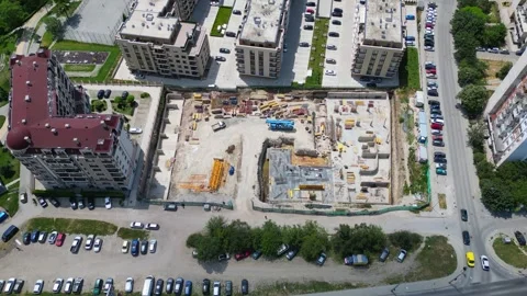 A drone flies around the construction pit of a new residential complex in the Stock Footage 278351495