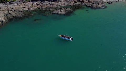 A drone flies around a floating boat in the lagoon of a picturesque tropical Stock Footage 147528482