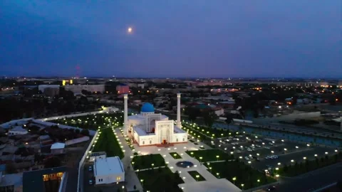 A drone flies around an illuminated mosque at night. Cloudy sky on the Stock Footage 271185183