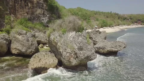 The drone flies around large rocks in the Indonesian sea. Stock Footage 155972763