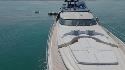 A drone flies around a luxury private yacht standing at sea against the backdrop Stock Footage 246735572