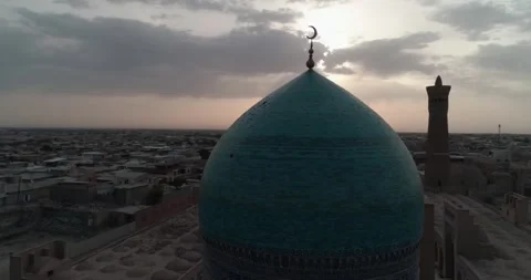 A drone flies around the Mir I Arab Madressa famous memorial complex in Bukhara Stock Footage 246624542