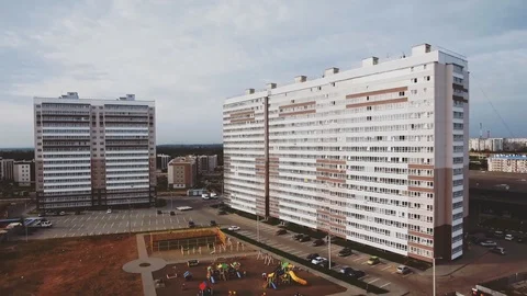 Drone flies around modern dormitory area apartment houses panel building new Stock Footage 129469526