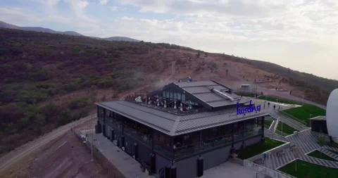 The drone flies around the mountain station of the cable car with a restaurant Stock Footage 253541047