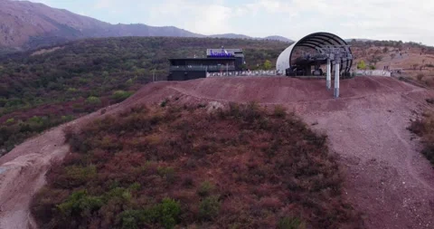 The drone flies around the mountain station of the cable car with a restaurant Stock Footage 258092783