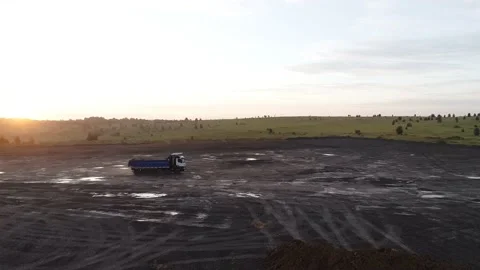 The drone flies around a powerful dump truck that is driving off-road in the Stock Footage 169589172