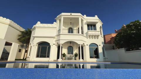 Drone flies around a private Arab villa with a swimming pool against the Stock Footage 272809992