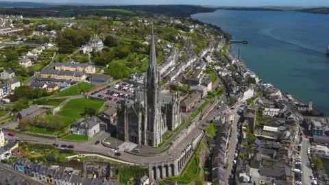 Drone flies around the St Colman's Cathedral towards the ocean Cobh, Ireland Stock Footage 267076732
