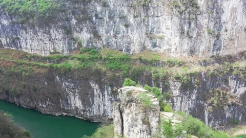 The drone flies around the top of the 100-meter cliff in the men's station. Stock Footage 311749864