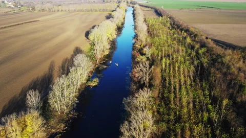 Drone flies around two small boats on a river with men fishing Stock Footage 263189886