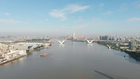 The drone flies away from the red bridge over the river. Stock Footage 113666798