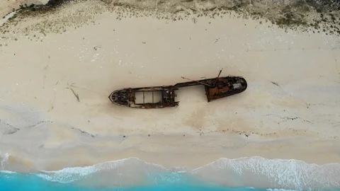 A drone flies back over Shipwreck Beach of Zakynthos Island on a sunny day Stock Footage 121971910
