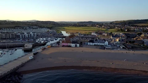 Drone flies back from West Bay beach Dorset Stock Footage 94364852