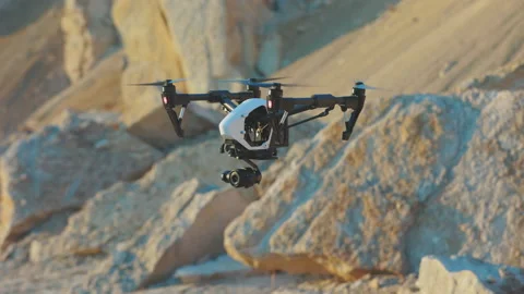 Drone flies on background rock. Modern technologies for shooting photos and Stock Footage 175403613