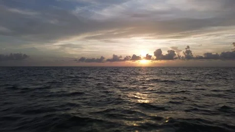 Drone Flies Backward Over Gulf of Mexico Waves at Golden Hour Stock Footage 345963371