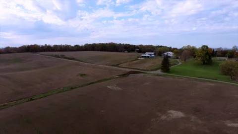 Drone Flies Backward over Open Plains with Distant Houses 動画素材 347151005