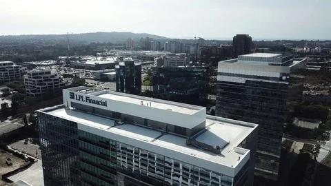 Drone flies backward from top of office building with mirrored windows Stock Footage 84950267
