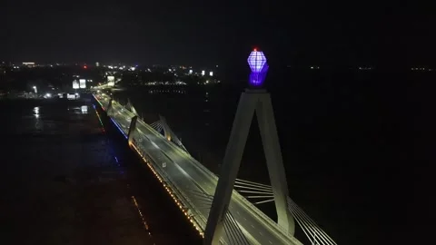 Drone flies backwards and descends from glowing gem atop bridge Stock Footage 342255527