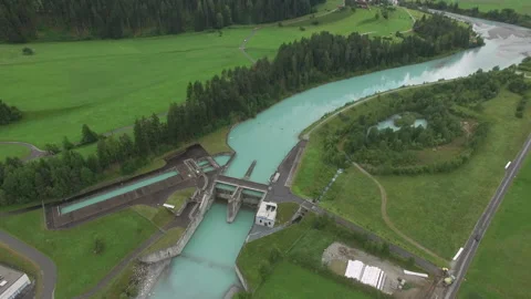 Drone flies backwards over an hydropower plant in Switzerland Stock Footage 145990640