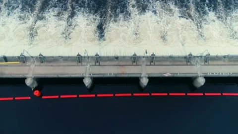 Drone flies backwards over a raging dam in full release as the camera tilts up. Stock Footage 136065835