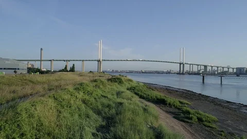 Drone flies backwards over Thames riverbank with QEII Bridge Stock Footage 92511134