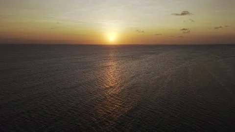 Drone flies backwards from sunset on the horizon of the water Stock-Footage 346159228