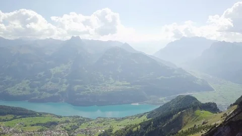 Drone flies backwards until a big mountain gets visible. On the mountain Stock Footage 97853052