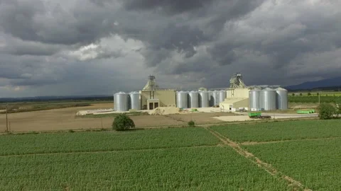 Drone flies backwards to a wheat and grain silo in France Stock Footage 145991221