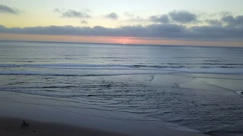 Drone flies behind palm trees over beach at sunset in Del Mar California Stock Footage 95063766