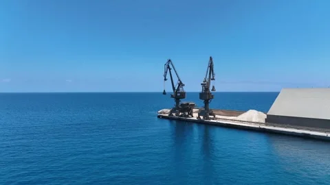 Drone Flies Between Old Cranes with Stunning Blue Horizon Behind Stock Footage 310143348