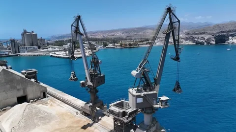 Drone Flies Between Rustic Cranes on Arguineguín Coastline, Ocean View Stock Footage 310143297