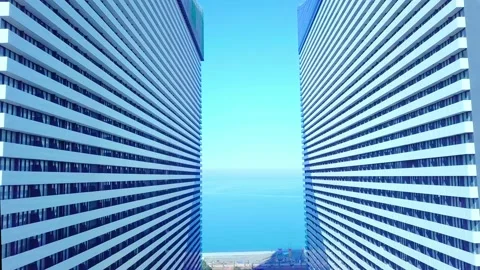 The drone flies between two buildings with glass windows. Stock Footage 171127370
